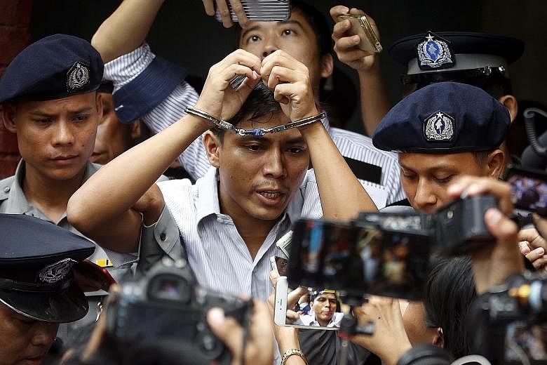 Reuters journalist Kyaw Soe Oo is escorted out of the Insein township court in Yangon after the verdict. He and fellow Reuters journalist Wa Lone say they were framed for the crime. The two men were reportedly invited to dinner by the police, given s