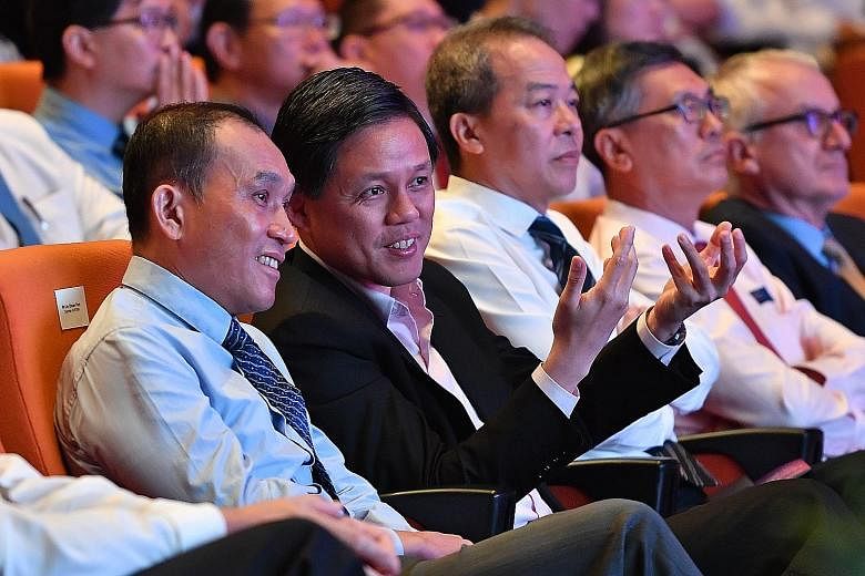 Minister Chan Chun Sing with A*Star chairman Lim Chuan Poh (far left) at the Leaders in Science Forum.