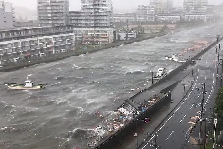 Boats floating along with debris in Nishinomiya City, in Hyogo prefecture, yesterday. Tides in some areas were the highest since a typhoon in 1961, NHK reported. Damage from loose construction scaffolding in Osaka in the aftermath of Typhoon Jebi yes