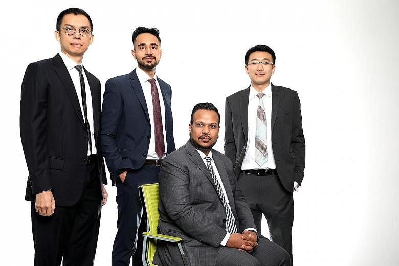 Mr Manish Tibrewal (seated), CEO of Tolaram's family office, with (from left) Mr Lee Kim Leng, head of macro, Mr Prashant Sirohi, assistant vice-president of operations, and Mr Liew Han Piow, head of equity derivatives.