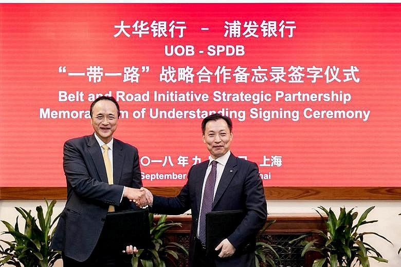 Mr Frederick Chin (left), head of group wholesale banking at UOB, and Mr Wang Xinhao, executive vice-president of Shanghai Pudong Development Bank, at yesterday's ceremony. The banks aim to help more companies tap opportunities in the BRI.