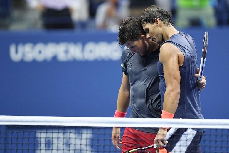 Spaniard Rafael Nadal (right) embracing Austrian Dominic Thiem after defeating him in their epic US Open match that ended in the wee hours of yesterday. Nadal overcame a "bagel" in the opening set and will play Juan Martin del Potro in the semi-final