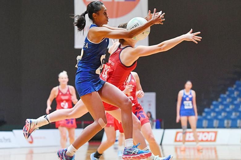 Singapore's Nurul Baizura keeping the ball beyond the reach of her Hong Kong opponent during their second-round game at the OCBC Arena. Singapore lost 50-49 to an older, more experienced Hong Kong side.