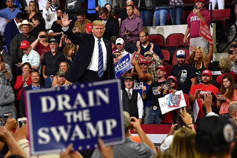 US President Donald Trump at a rally in Billings, Montana, on Thursday. He questioned whether the anonymous op-ed was an act of treason, and called it "a threat to democracy itself".