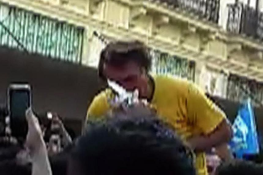Mr Jair Bolsonaro (above) reacting after being stabbed in the abdomen during a rally in Juiz de Fora, Brazil, on Thursday. In a screen grab (left), the knife can be seen.