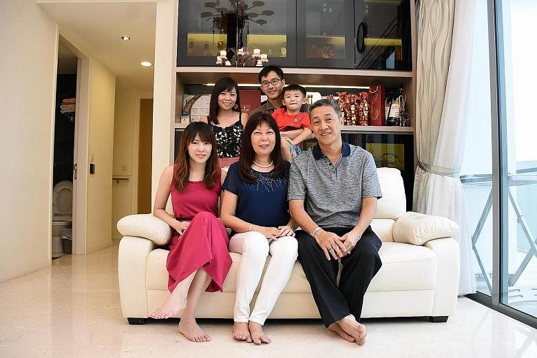 Mr Victor Lim, 60, with his wife Stella Leong, 60, and daughter Dina, 30, on the sofa. Behind him are his son Winchester, 34, daughter-in-law Joanne Teng, 34, and grandson Xavier, five. Mr Lim bought the three-storey, 3,500 sq ft penthouse at Skies Milton