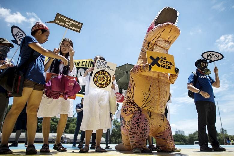 PHILIPPINES: (Far left) Protesters denouncing coal and fossil fuel industries. THAILAND: (Left) Activists in front of the UN office in Bangkok, where delegates were scrambling to breathe life into the Paris Agreement on climate change.