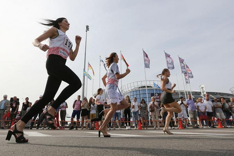 Dozens of women pounding a 100m runway in nothing short of 5cm heels in the High Heel Race yesterday in Minsk, Belarus. High heel runs that pit women - and sometimes men - against each other in the name of fun and for the chance to win prizes have ga
