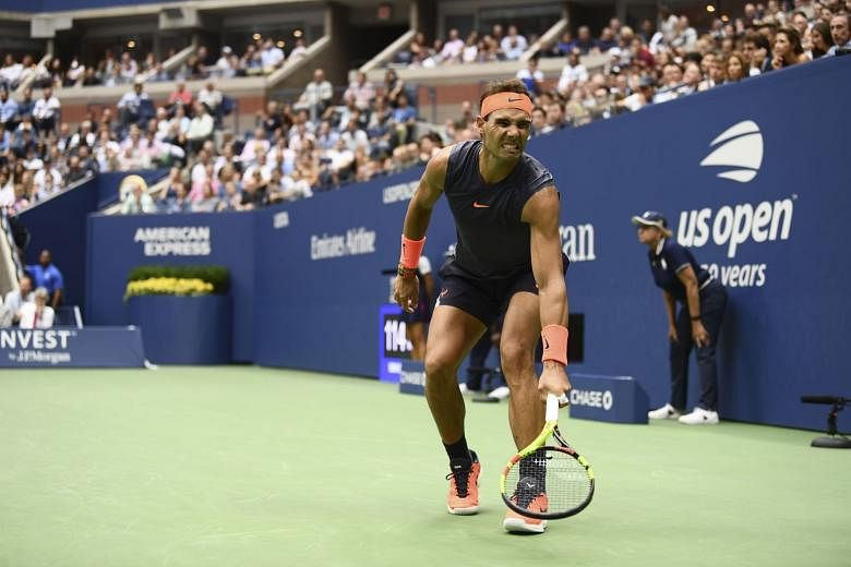 Rafael Nadal (above) grimaces as he lunges for a shot during his semi-final clash with Argentina’s Juan Martin del Potro in the Arthur Ashe Stadium on Friday. The Spaniard retired after losing the first two sets as his right knee gave way, with del Potro 