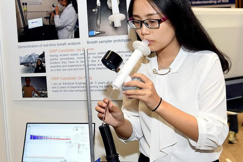 Dr Jia Zhunan demonstrating the device that is able to test for lung cancer just from a person's breath. The analysis can be done within seconds.