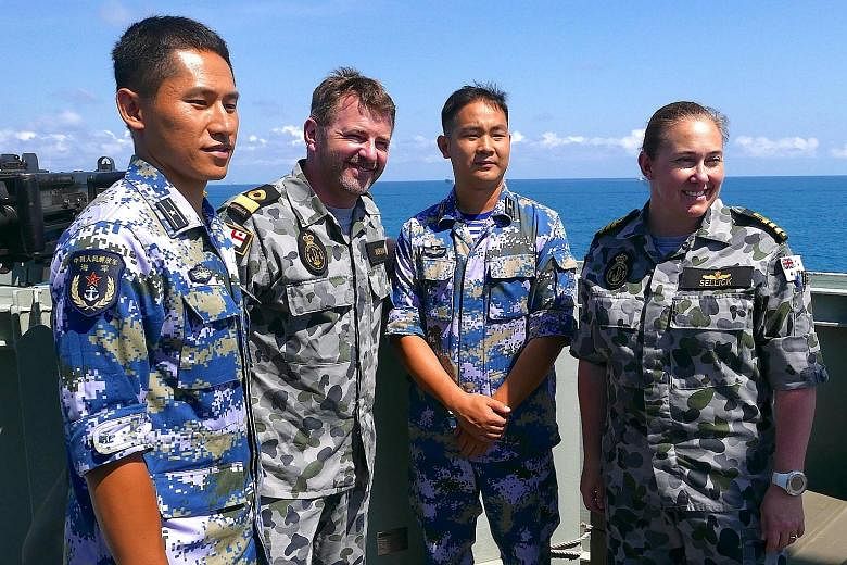 Royal Australian Navy officers with their Chinese counterparts during Exercise Kakadu off Darwin. This is the first time that China is taking part.