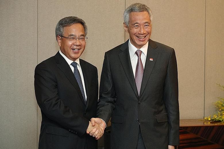 Prime Minister Lee Hsien Loong with Chinese Vice-Premier Hu Chunhua in Hanoi yesterday. They reaffirmed the strong economic cooperation between Singapore and China during their meeting.