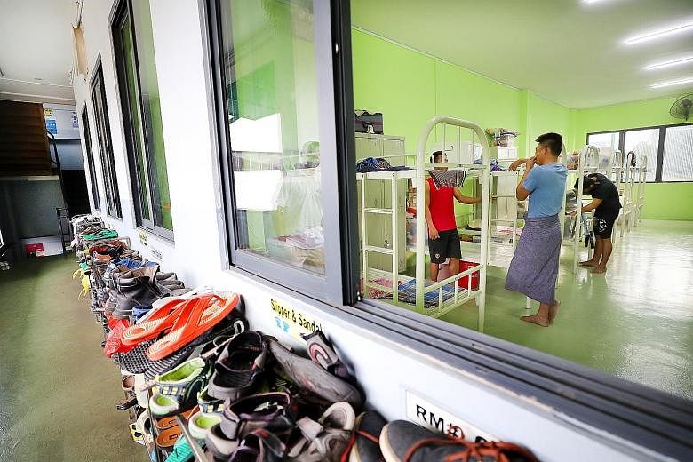 Above: Utoc's dormitory in Boon Lay can house about 240 workers Left: Dormitory assistant Paliyandi Meganathan, 34, arranges the cleaned garments for workers to collect. Dorm residents do not have to pay extra for laundry service. Left: Welder Sheikh