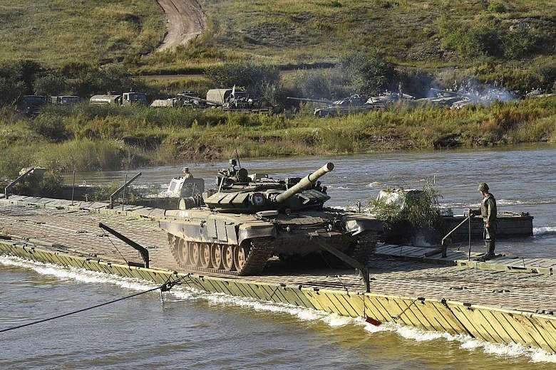 A Russian Ministry of Defence photo shows military equipment, tanks and motorised rifle divisions crossing the Onon river during Vostok-2018 yesterday.
