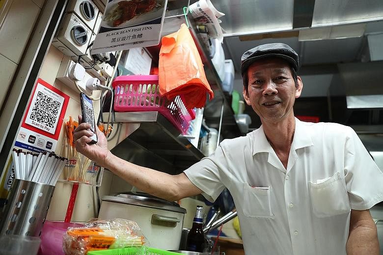 Mr Lim Heng, who sells hor fun at Old Airport Road Food Centre, says he sees the need to go cashless if that is the future. Nets will now be the single touchpoint for about 20 payment schemes at hawker centres, canteens and coffee shops.