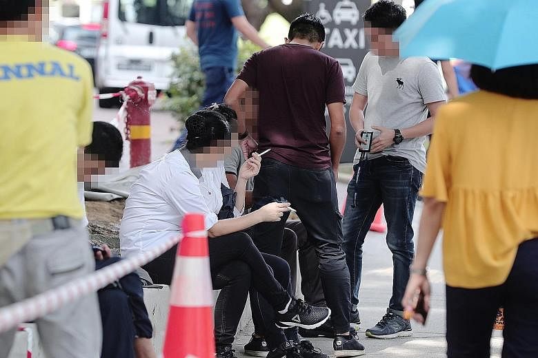 Singapore Customs officers checking whether people were smoking duty-unpaid cigarettes in Tampines Central. Offenders caught in the three-day operation were issued composition sums ranging from $500 to $1,200.