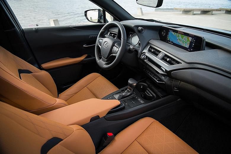 The interior of the Lexus UX200 includes a dash top lined with a surface reminiscent of Japanese washi paper, a large infotainment screen paired with a user-friendly touchpad, and hi-fi controls recessed in the beak of the centre armrest. The Lexus U