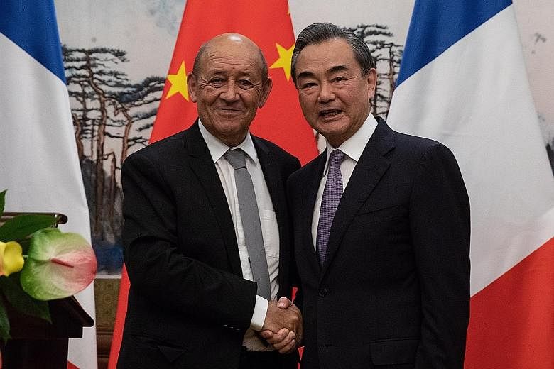 Visiting French Foreign Minister Jean-Yves Le Drian with his Chinese counterpart, State Councillor Wang Yi, at their press conference following a meeting at the Diaoyutai State Guesthouse in Beijing on Thursday.