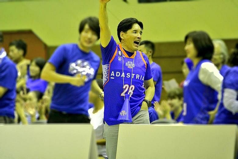Mr Hori cheering on his professional basketball team, Ibaraki Robots, with his wife and one of his five sons. Globis Management School founder Yoshito Hori believes in the power of education and in giving back to the community. Among his many initiat