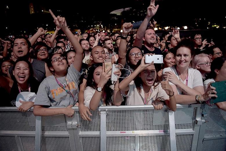 Above: Lewis Hamilton celebrating his hard-won pole in what he called "a hardcore qualifying session". Left: Fans at the Liam Gallagher concert. The singer thrilled the audience with his hour-long set at the Padang stage.