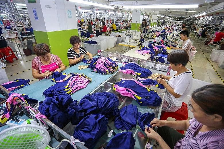Workers at a swimwear factory in Jinjiang in China's eastern Fujian province. Wall Street pared gains just before closing last Friday, following a Bloomberg report that US President Donald Trump had instructed aides to go ahead with the next round of tari