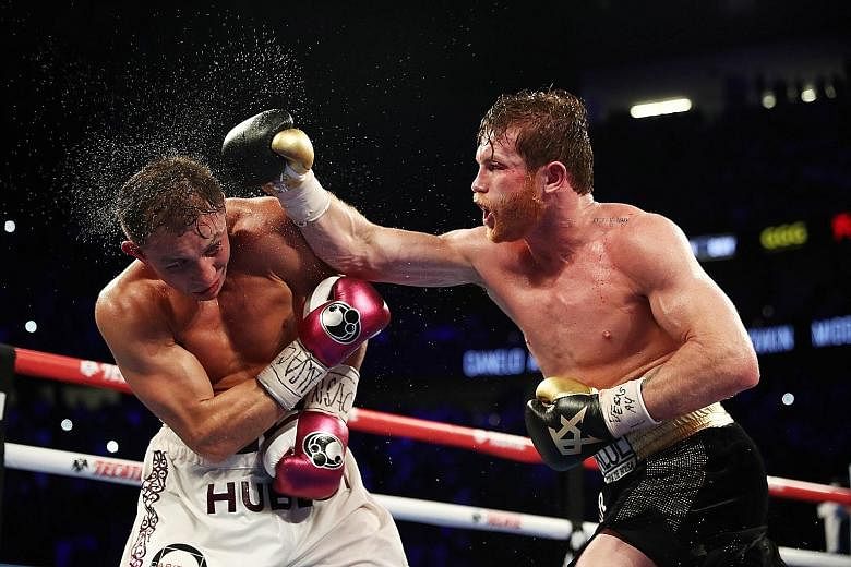 Saul Alvarez lands a right hook on Gennady Golovkin during their WBC/WBA middleweight title fight at the T-Mobile Arena in Las Vegas on Saturday. Alvarez won by a majority decision after 12 rounds.