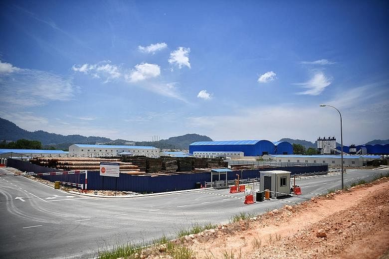 Above: A billboard still advertises the rail project in Kota Sultan Ahmad Shah, in Kuantan, even though it has been suspended indefinitely. Left: A China Communications Construction Company (CCCC) site in Bentong, Pahang. Below: A CCCC site in Temerl