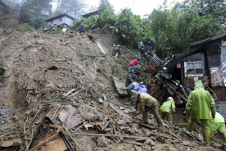 Rescuers and volunteers search for three missing persons after Typhoon Mangkhut triggered a landslide in Balacbac, Baguio City, north of Manila. Scores of people have died but the storm's initial casualty toll was far lower than officials had feared.