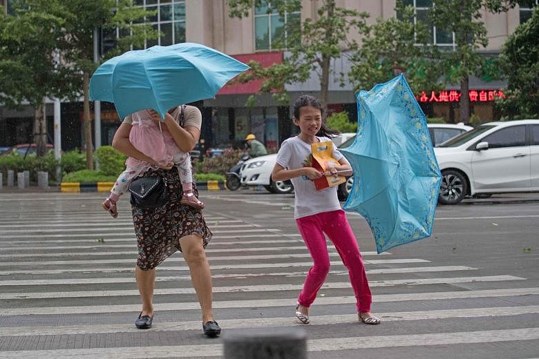 People battling strong winds ahead of Typhoon Mangkhut's arrival in Yangjiang, in China's Guangdong province, yesterday.