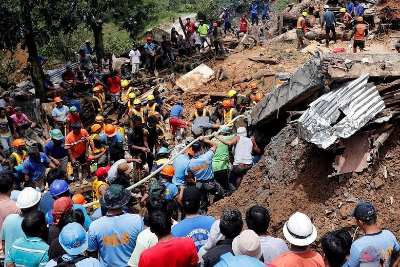 Rescuers searching for people trapped in a landslide caused by Typhoon Mangkhut at a small-scale mining camp in Itogon in the Philippines yesterday.