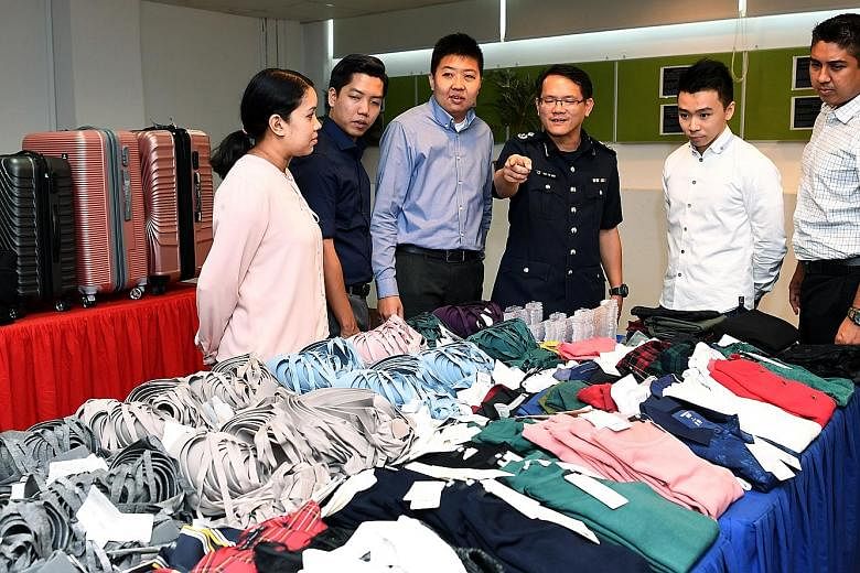 Assistant Commissioner of Police Tan Tin Wee (fourth from left) and officers who helped bust the syndicate with the stolen goods. The police described it as the largest shop theft case, in terms of value and volume, that they have come across in rece
