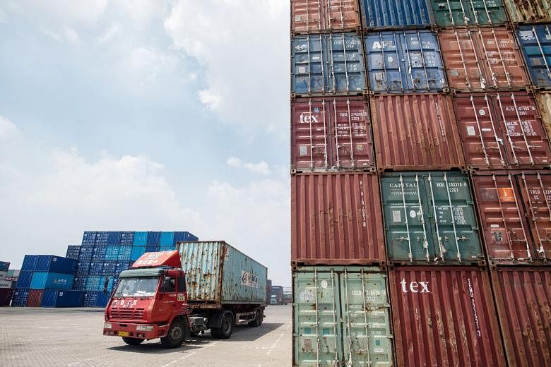 Stacked containers at a port in Zhangjiagang, China. Singapore's exports to China - its biggest single market - fell 17.8 per cent year on year last month.