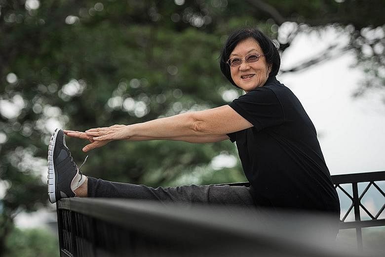 Mrs Lee Yen limbering up with squats and stretching exercises. The 67-year-old used to suffer from pain in her soles and kneecaps after brisk walking, but that eased after she took part in an exercise programme to help seniors build stronger muscles.