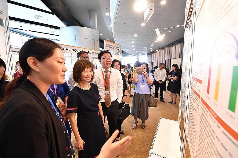 Senior Minister of State for Health Amy Khor viewing exhibits at the Quality and Productivity Festival organised by the Agency for Integrated Care yesterday. At the festival, the AIC presented awards to more than 400 individuals and teams for excelle