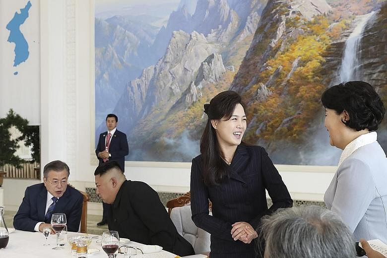 Above: North Korean leader Kim Jong Un (second from left) and his wife Ri Sol Ju (third from left) had lunch with South Korean President Moon Jae-in and First Lady Kim Jung-sook at Pyongyang's famous cold noodle restaurant Okryu-gwan yesterday. Right