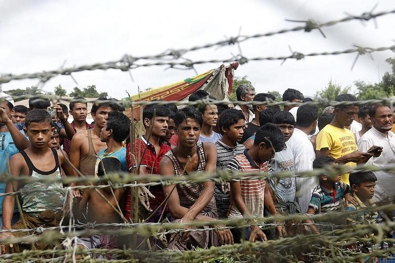 Rohingya refugees in the "no man's land" zone at the Bangladesh-Myanmar border in Rakhine State, western Myanmar, on Aug 24. The International Criminal Court's preliminary probe will look into allegations of killings, sexual violence and forced depor