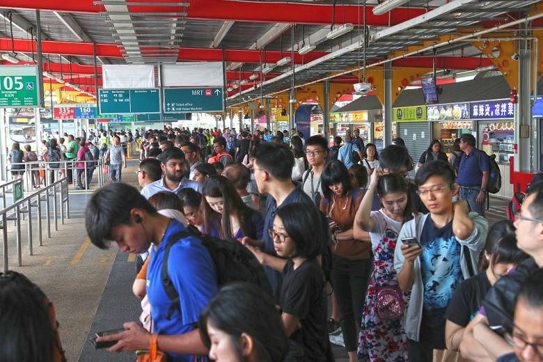 SMRT staff at work on the tracks after a glitch affected a switch that allows trains to change tracks. SMRT said East-West Line trains at Jurong East and Clementi stations had to halt temporarily for up to five minutes every time engineering staff we