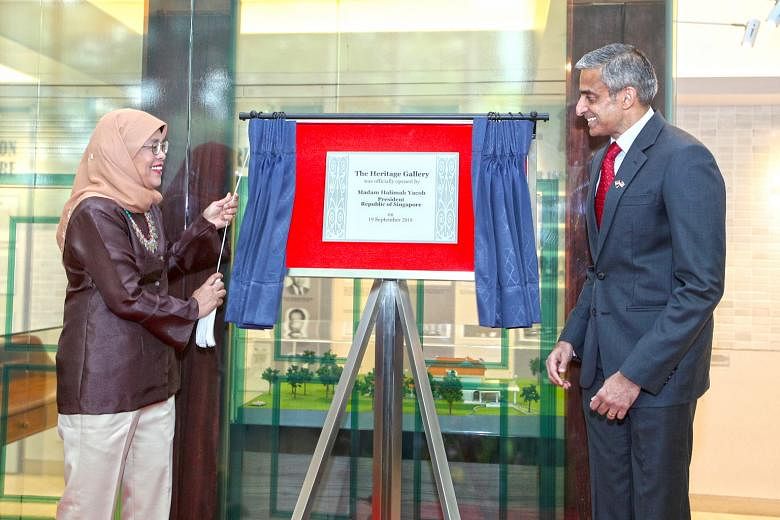 President Halimah Yacob opening a new heritage gallery that documents historic moments in the ties between the two countries at the Singapore High Commission in Kuala Lumpur yesterday. Beside her is Singapore's High Commissioner to Malaysia Vanu Gopa