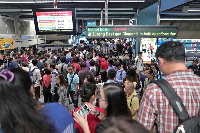 SMRT staff at work on the tracks after a glitch affected a switch that allows trains to change tracks. SMRT said East-West Line trains at Jurong East and Clementi stations had to halt temporarily for up to five minutes every time engineering staff we