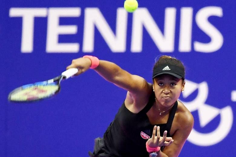 US Open champion Naomi Osaka hitting a return against Slovakia's Dominika Cibulkova during her 6-2, 6-1 last-16 win at the Pan Pacific Open in Tokyo yesterday. It was the first match for the Japanese player since she won her maiden Grand Slam and she prov