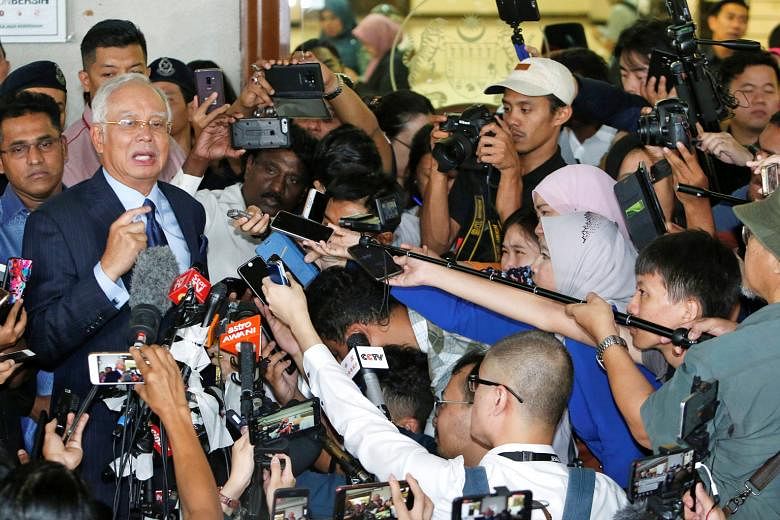 Najib Razak speaking to the media at a Kuala Lumpur court yesterday. He told reporters that the court case would be an opportunity for him to clear his name. The charges filed against the former leader at his third court appearance were related to th