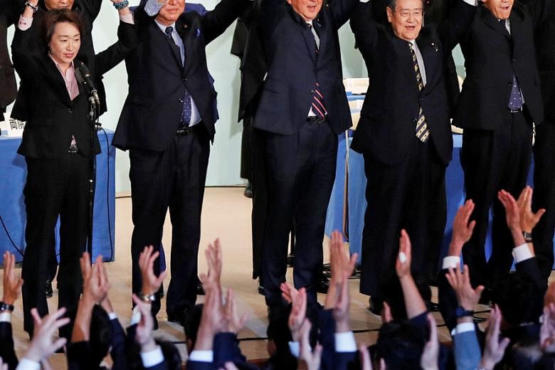 Japan's Prime Minister Shinzo Abe and his Liberal Democratic Party members cheering after he won the leadership vote yesterday. He will reshuffle his Cabinet after returning from a trip to New York for a United Nations General Assembly gathering next