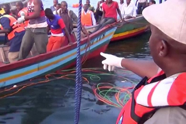Rescue workers at the scene where a ferry overturned in Lake Victoria, Tanzania, yesterday.