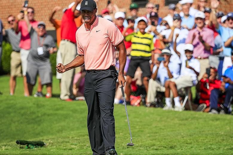 The roaring good times are back, with the crowd cheering Tiger Woods after his eagle on the 18th in the Tour Championship first round at East Lake Golf Club in Atlanta, Georgia, on Thursday.