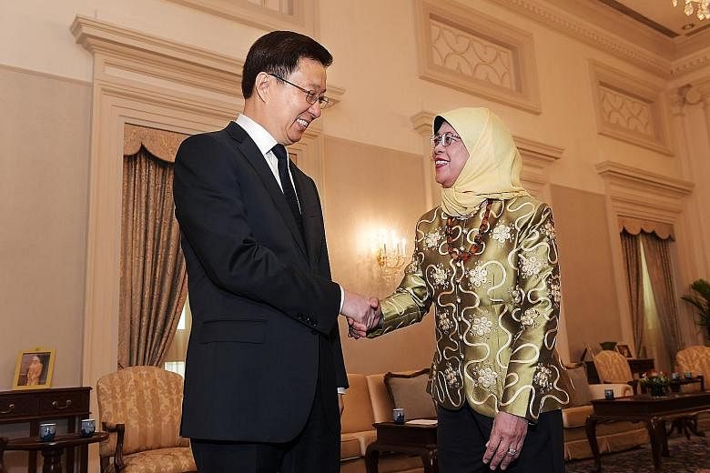 Chinese Vice-Premier Han Zheng meeting President Halimah Yacob (above) and Prime Minister Lee Hsien Loong (right) at the Istana yesterday. The three leaders said they look forward to the conclusion of the China-Singapore Free Trade Agreement negotiat