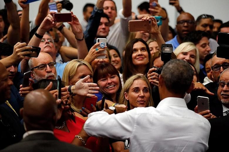 Mr Barack Obama (above, at a rally in Anaheim, California) is campaigning with the message #TakeItBack; while US President Donald Trump (left, at a rally in Wilkes-Barre, Pennsylvania) leads the charge for Republican candidates.