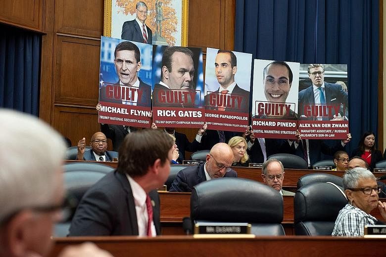 Posters of those who have pleaded guilty to charges stemming from the Mueller investigation into Russian meddling in the 2016 US presidential election being displayed during a House committee hearing on Capitol Hill in Washington on July 12 this year