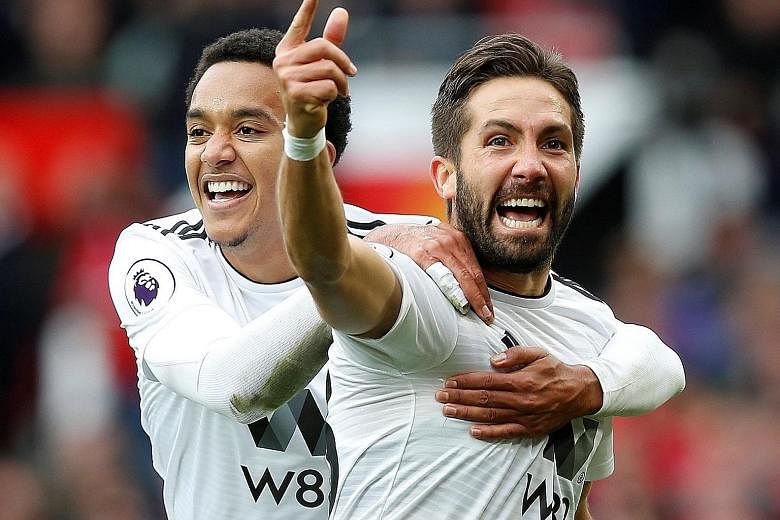 Joao Moutinho celebrating his 53rd-minute goal against Manchester United with Helder Costa yesterday. Wolverhampton Wanderers had looked nothing like a promoted team, playing confident and composed football and were rewarded with the fine team goal.