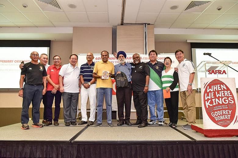 Home Affairs & Law Minister K. Shanmugam with a copy of When We Were Kings at yesterday's launch. Others are (from left) Sumardi Sarkawi, Song Koon Poh, Shee Lay Toon, Tay Huai Eng, Natahar Bava, Jarmal Singh, Godfrey Robert, Alfred Lee, Rose Bava an