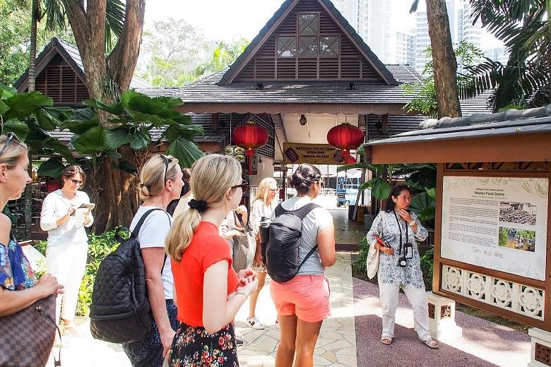 A scene from Crazy Rich Asians, which was filmed at Chijmes in Victoria Street. The nightspot is part of the itinerary for some tours based on the movie. Tourists listening to guide Catalina Tong during a visit to Newton Food Centre as part of a Craz